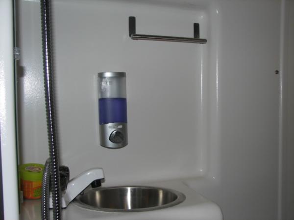 Soap Dispenser and Towel Bar. Dispenser is from HomeDepot. Towel Bar is from Amazon. Both are attached with tape.