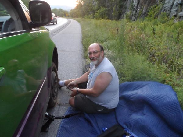 Changing the tire at the side of the Interstate in Vermont, after waiting two hours.  AAA contractors refused to come - "too dangerous."  Tire "blew out" when the metal valve stem attaching the pressure indicator inside the tire to the rim fatigued and broke.  A minor inconvenience that could have been much worse.